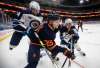 Jets' Derek Forbort (24) and Dylan DeMelo (right) fight for the puck with Oilers' Alex Chiasson last Wednesday in Edmonton. 