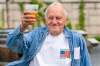 George Ripley, 72, holds up his free beer after receiving COVID-19 vaccine shot in Washington. Free beer among the latest White House-backed incentives for Americans to get vaccinated for COVID-19.  (Jacquelyn Martin / The Associated Press)