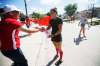 Kelsey Wog shakes hands with neighbour Gary Liu at a send-off held by her neighbours before she heads to Toronto for the Canadian Olypmic swimming trials. (John Woods / Winnipeg Free Press)