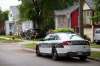 Daniel Crump / Winnipeg Free Press. A police cruiser is parked on Burrows avenue near the spot where a 12-year-old youth was murdered Friday evening. June 19, 2021.