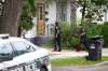 Police officers canvas the 200 block of Burrows Avenue after a 12-year-old youth was fatally stabbed Friday evening. (Daniel Crump / Winnipeg Free Press)