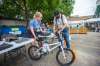 Lasha Mackedenski, with WRENCH, hands Bruce Neil one of 30 free children's bikes while at a pop-up vaccine clinic at the North End Women's Centre in Winnipeg on June 23. Mikaela MacKenzie / Winnipeg Free press files
