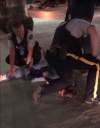 An officer kneels on the neck of Nathan Lasuik during a 2019 arrest at the Winnipeg airport. (Supplied)