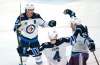 Winnipeg Jets' Paul Stastny, right, celebrates his third period goal against the Montreal Canadiens with teammates Mark Scheifele, left, and Neal Pionk in NHL hockey action in Montreal on Thursday, March 4, 2021. THE CANADIAN PRESS/Paul Chiasson