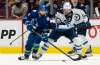 Vancouver Canucks' Phillip Di Giuseppe (left) is checked by Winnipeg Jets' Michael Eyssimont during the first period of NHL preseason hockey action in Vancouver, Sunday. THE CANADIAN PRESS/Richard Lam