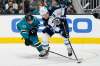 Jeff Chiu / The Associated Press
San Jose Sharks center Logan Couture, left, reaches for the puck next to Winnipeg Jets centre Mark Scheifele during the first period of an NHL hockey game in San Jose.