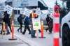 James Hare, professor emeritus of biological sciences (centre), intermittently stops traffic while on the picket line on University Crescent at the University of Manitoba in Winnipeg on Tuesday. (Mikaela MacKenzie / Winnipeg Free Press)