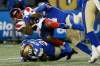 Winnipeg Blue Bombers linebacker Adam Bighill (top) tackles Montreal Alouettes&rsquo; Cameron Artis-Payne Saturday night at IG Field. The Blue won their 11th game of the season and their ninth in a row. (John Woods / The Canadian Press files)