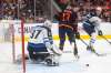 Winnipeg Jets' Connor Hellebuyck makes a save on Edmonton Oilers' Jesse Puljujarvi as Logan Stanley defends during the second period in Edmonton on Thursday. THE CANADIAN PRESS/Jason Franson