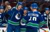 Vancouver Canucks' Kyle Burroughs (middle) celebrates with teammates Tyler Myers (left) and Elias Pettersson after scoring a goal against the Winnipeg Jets during the second period. THE CANADIAN PRESS/Rich Lam