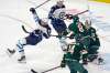 Minnesota Wild's Jordie Benn gets his stick tangled up with Winnipeg Jets' Pierre-Luc Dubois who falls during the third period Friday in St. Paul, Minn. The Wild won 7-1. (AP Photo/Jim Mone)