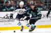 Elaine Thompson / The Associated Press
Jets' Adam Lowry (left) races for the puck with former linemate Brandon Tanev of the Seattle Kraken.