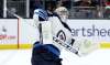 Winnipeg Jets' goaltender Connor Hellebuyck stops the puck up high during the second period. The netminder made 25 saves to earn his first shutout of the season. (TREVOR HAGAN / WINNIPEG FREE PRESS)