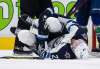 Winnipeg Jets' Blake Wheeler clutches his knee as he lies on the ice after getting injured during the third period against the Canucks in Vancouver, on Friday. THE CANADIAN PRESS/Darryl Dyck