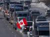 A trucker convoy driving to Parliament Hill in Ottawa to participate in a cross-country truck convoy protesting measures taken by authorities to curb the spread of COVID-19 and vaccine mandates makes it’s way on the highway near Kanata, Ont. on Saturday, Jan. 29, 2022. (Frank Gunn / The Canadian Press)