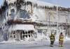 Firefighters stand outside the ice-encrusted remains of Kirkwood Block, which was destroyed by a fire on Feb. 2. (Brent Bellamy)