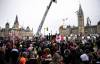 Justin Tang / The Canadian Press
People listen to a sermon delivered by a pastor from the back of a flatbed truck parked on Wellington Street in front of Parliament Hill on Sunday.