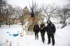 Volunteer fire keepers Holly Enns (left) with her partner Daniel “Kuya” Caneda (right), with full-time fire keeper John Butler (centre). (Mike Deal / Winnipeg Free Press)