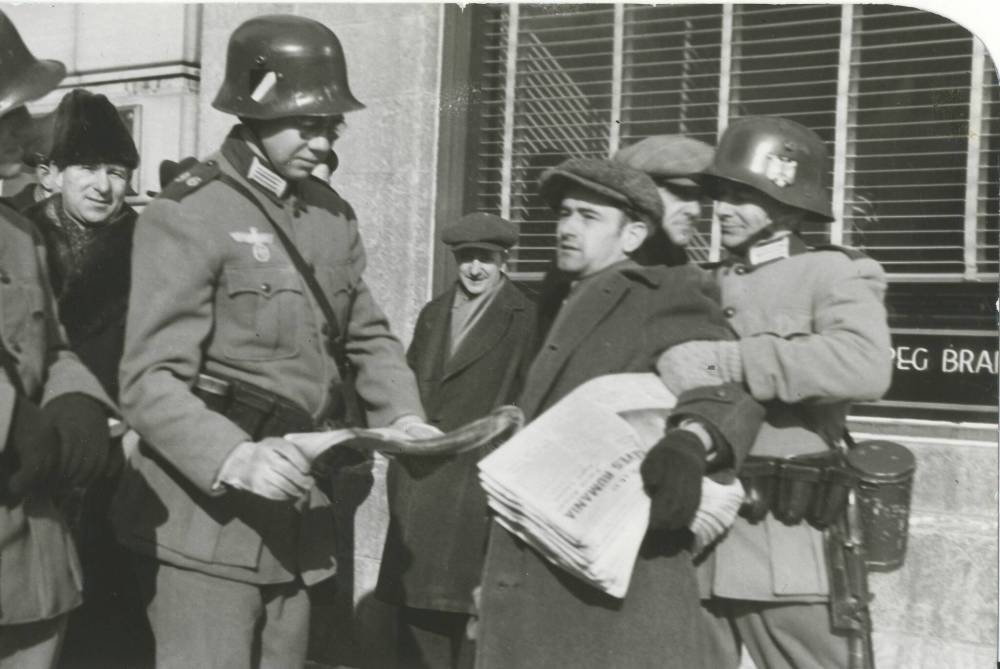 Winnipeg Free Press Archives If Day - World War II - (13) Feb. 19, 1942 Nazi Storm Troopers Demonstrate Invasion Tactics Squad of storm troops grabs Henry Weppler, Free Press newsie. fparchive