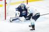 Winnipeg Jets goaltender Eric Comrie  stops Seattle Kraken’s Jordan Eberle as his shot goes off the post during the second period. THE CANADIAN PRESS/John Woods