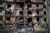 Emilio Morenatti/The associated Press
A man walks past a building damaged by a rocket attack in Kyiv, Ukraine, on Feb. 25.