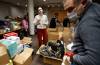 JOHN WOODS / WINNIPEG FREE PRESS Anna Karpenko, centre, talks to a volunteer as they pack boxes of requested essentials at the Ukrainian National Federation Tuesday.