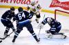 Winnipeg Jets goaltender Connor Hellebuyck covers up the loose puck for one of his 42 saves in their 4-0 win over the Vegas Golden Knights in Winnipeg on Tuesday. THE CANADIAN PRESS/Fred Greenslade