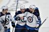 Blake Wheeler (right) celebrates with Neal Pionk (center) and Mark Scheifele after scoring during the shootout against Buffalo on Wednesday. (Adrian Kraus / The Associated Press)