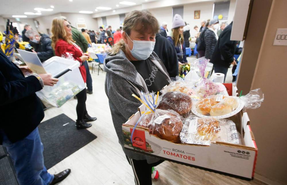 Val Peters heads home after purchasing her Ukrainian items for her Easter dinner at the Easter Ukrainian Market at the Sts. Vladimir and Olga Cathedral parish hall Sunday. The sale was supplied by donors and all proceeds are going to relief efforts overseas. (John Woods / Winnipeg Free Press)