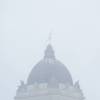 The Golden Boy statue stands tall, but barely visible atop the Manitoba Legislative Building in Winnipeg, Wednesday, during a spring snowstorm. THE CANADIAN PRESS/Mike Sudoma