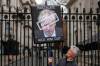 Frank Augstein / AP Photo
A protester outside 10 Downing Street in London holds a sign showing British Prime Minister Boris Johnson, who was fined for breaching COVID-19 regulations.