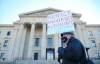 MIKE DEAL / WINNIPEG FREE PRESS
A striking professor marches outside the Manitoba Legislature.