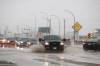 Motorists navigate deep water and a large hidden pothole on Route 90 just north of Dublin Avenue. (Daniel Crump / Winnipeg Free Press)