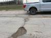 The stretch of Saskatchewan between Cavalier Drive and Buchanan Boulevard is riddled with potholes. (Malak Abas / Winnipeg Free Press)