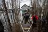 Cabin owner Michael Chontske (left) and his friend Tracy Lysak are doing what they can to protect Chonstke’s cabin and property as the water on Eleanor Lake continues to rise Saturday afternoon. (Daniel Crump / Winnipeg Free Press)