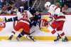 THE CANADIAN PRESS/Fred Greenslade
Winnipeg Jets' Mark Scheifele is checked by Carolina Hurricanes' Brian Gibbons as Trevor Van Riemsdyk looks for the loose puck during the second period in Winnipeg Tuesday.
