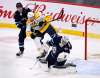 Winnipeg Jets' goaltender Connor Hellebuyck (37) makes a save as Nashville Predators' Yakov Trenin (32) looks for the rebound in front of Dmitry Kulikov (7) during first period NHL action in Winnipeg on Sunday Jan. 12, 2020. (Fred Greenslade / The Canadian Press)