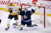 FRED GREENSLADE / THE CANADIAN PRESS
Winnipeg Jets goaltender Connor Hellebuyck makes a save on a shot from the point as Nashville Predators' Yakov Trenin looks for the deflection during the first period in Winnipeg on Tuesday.