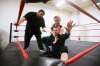 Pro wrestler A.J. Sanchez instructs as improviser George Hudson puts Steven Stashko into a chin lock during training. The performative link between acting and wrestling is a natural one. (John Woods / Winnipeg Free Press)