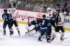 Chicago Blackhawks' Ryan Carpenter (22) celebrates his goal on Winnipeg Jets' goaltender Connor Hellebuyck (37) with teammates during first period NHL action in Winnipeg on Sunday, Feb. 16, 2020. THE CANADIAN PRESS/Fred Greenslade