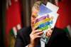 JOHN WOODS / WINNIPEG FREE PRESs fileS
Premier Brian Pallister holds up a copy of his government’s 2017 climate plan at a news conference on Wednesday.