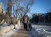 Vic Pereira walks with his guide dog Porthos near his home on Wellington Crescent. Pereira thinks the city should require those who own homes or businesses to shovel the sidewalks beside them. (Jessica Lee / Winnipeg Free Press)