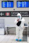 Chris Young / The Canadian Press
A traveller stands in the international arrivals hall at Toronto’s Pearson Airport.