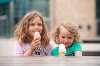 Sisters Avery (left) and Autumn Carroll enjoy ice cream on The Forks patio Saturday afternoon. (Mike Sudoma / Winnipeg Free Press)