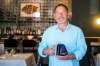 Scot McTaggart, owner of Fusion Grill, with the air purifier that will be installed in the restaurant’s ventilation system next week. (Mikaela MacKenzie / Winnipeg Free Press files)