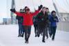 Junel Malapad, left, celebrates after completing his first lap of his 200-km charity run in Winnipeg on Sunday. (JOHN WOODS / WINNIPEG FREE PRESS)