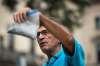 JESSE BOILY / WINNIPEG FREE PRESS
Dennis LeNeveu, a concerned resident, shows a sample of shale from about 200 feet below the surface brought up with the sand by CanWhite exploratory drilling in 2019 to media outside the Legislature building on Thursday.