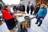 Daniel Crump / Winnipeg Free Press. Kiri Butter (left), from Thunder Bay, demonstrates how to prepare cured meat to onlookers at Festival du Voyageur Saturday afternoon. February 15, 2020.