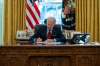 Evan Vucci / The Associated Press FILES
U.S. President Joe Biden signs an executive order in the Oval Office.