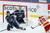 Winnipeg Jets' Nathan Beaulieu (88) blocks the shot by Calgary Flames' Dillon Dube (29) in front of goaltender Connor Hellebuyck (37) during third period NHL action in Winnipeg on Thursday, February 4, 2021. THE CANADIAN PRESS/John Woods